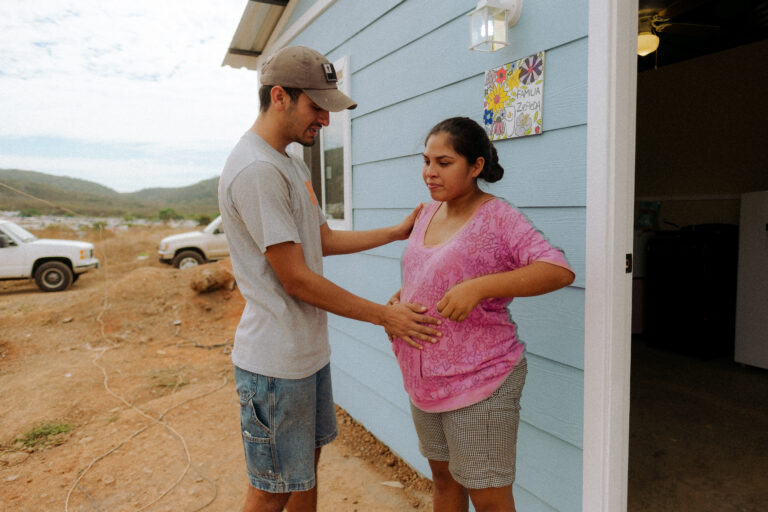 Zepeda family embracing each other outside their new home.